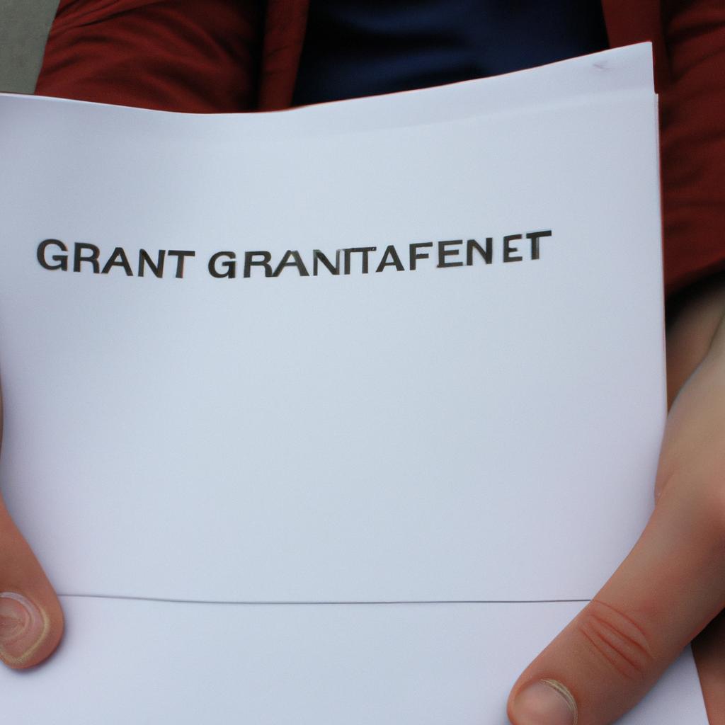 Person holding grant application papers